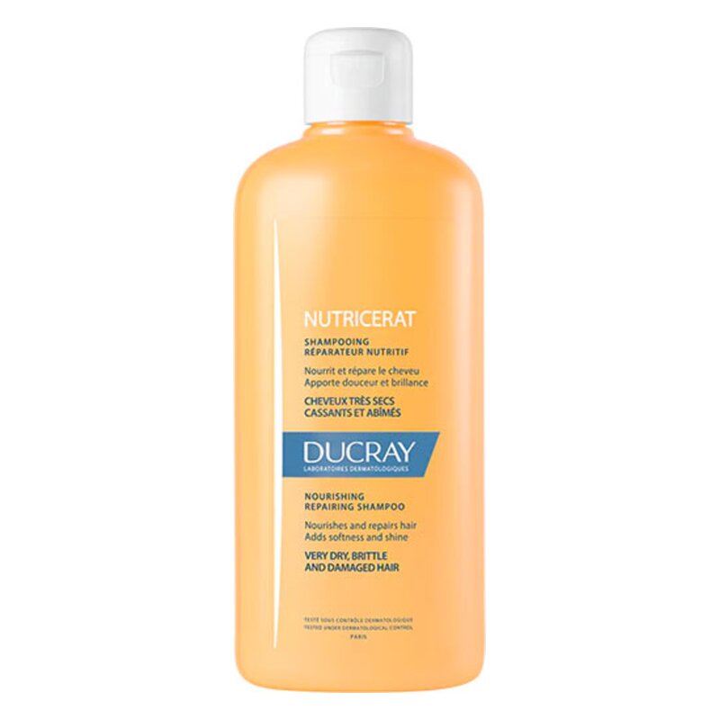 Flasche mit nährendem Reparatur-Shampoo für sehr trockene und beschädigte Haare von Ducray in orangefarbenem Design.