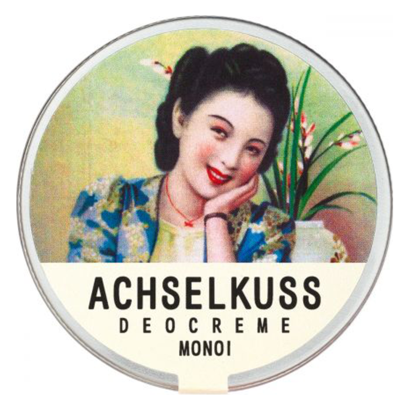 Runde Dose mit einer Frau, die lächelt, und dem Aufdruck "ACHSSELKUSS DEOCREME MONOI".